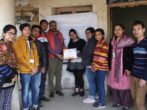 Beneficiary receiving certificate of participation towards the end of completing all the steps of Swasthya Pahal initiative